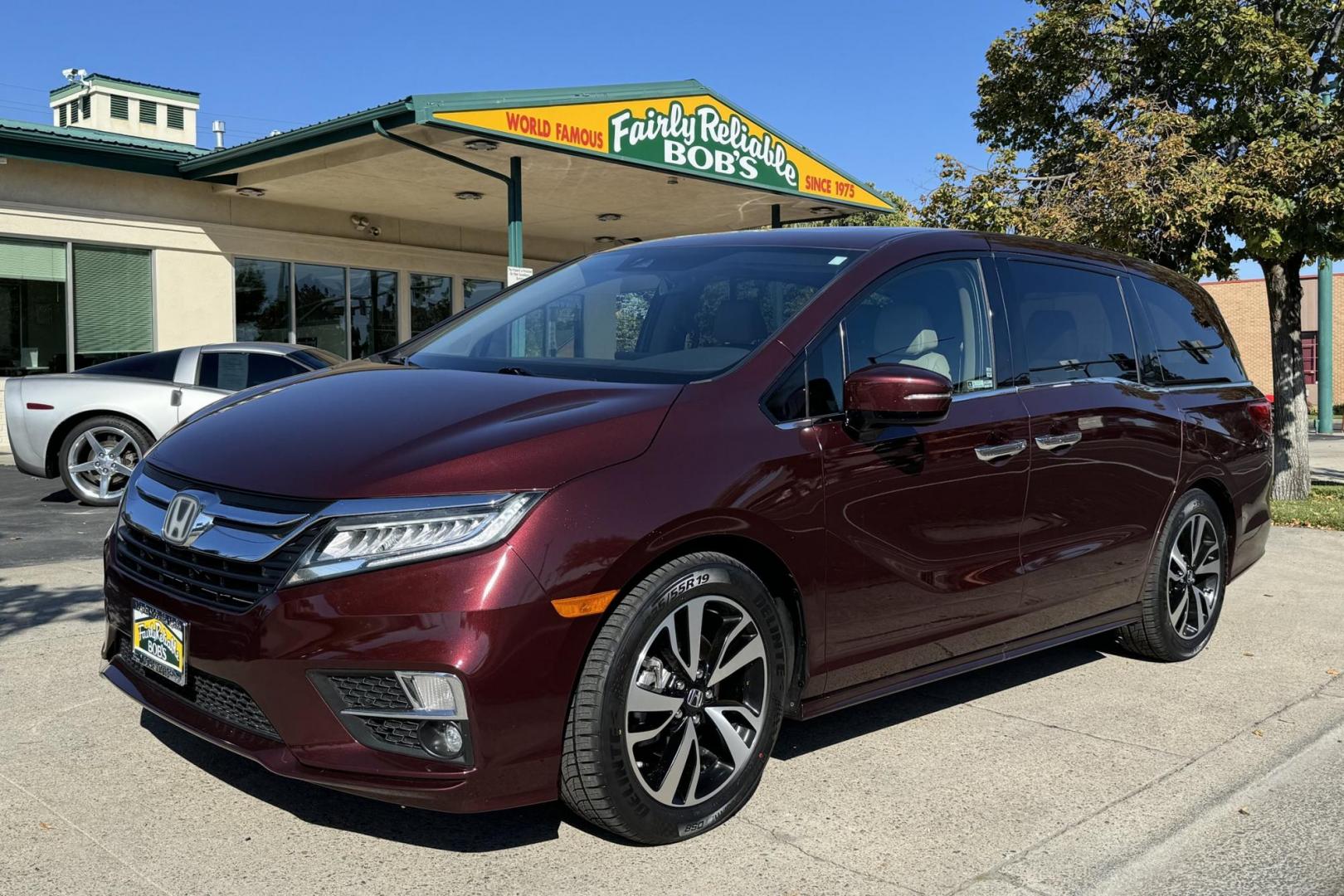 2019 Radiant Red Metallic /Light Oak Honda Odyssey Elite (5FNRL6H94KB) with an V6 3.5 Liter engine, Automatic 10 Speed transmission, located at 2304 W. Main St., Boise, ID, 83702, (208) 342-7777, 43.622105, -116.218658 - Hauls 8 People And Will Entertain The Passengers With A Factory Blu Ray DVD System. - Photo#0