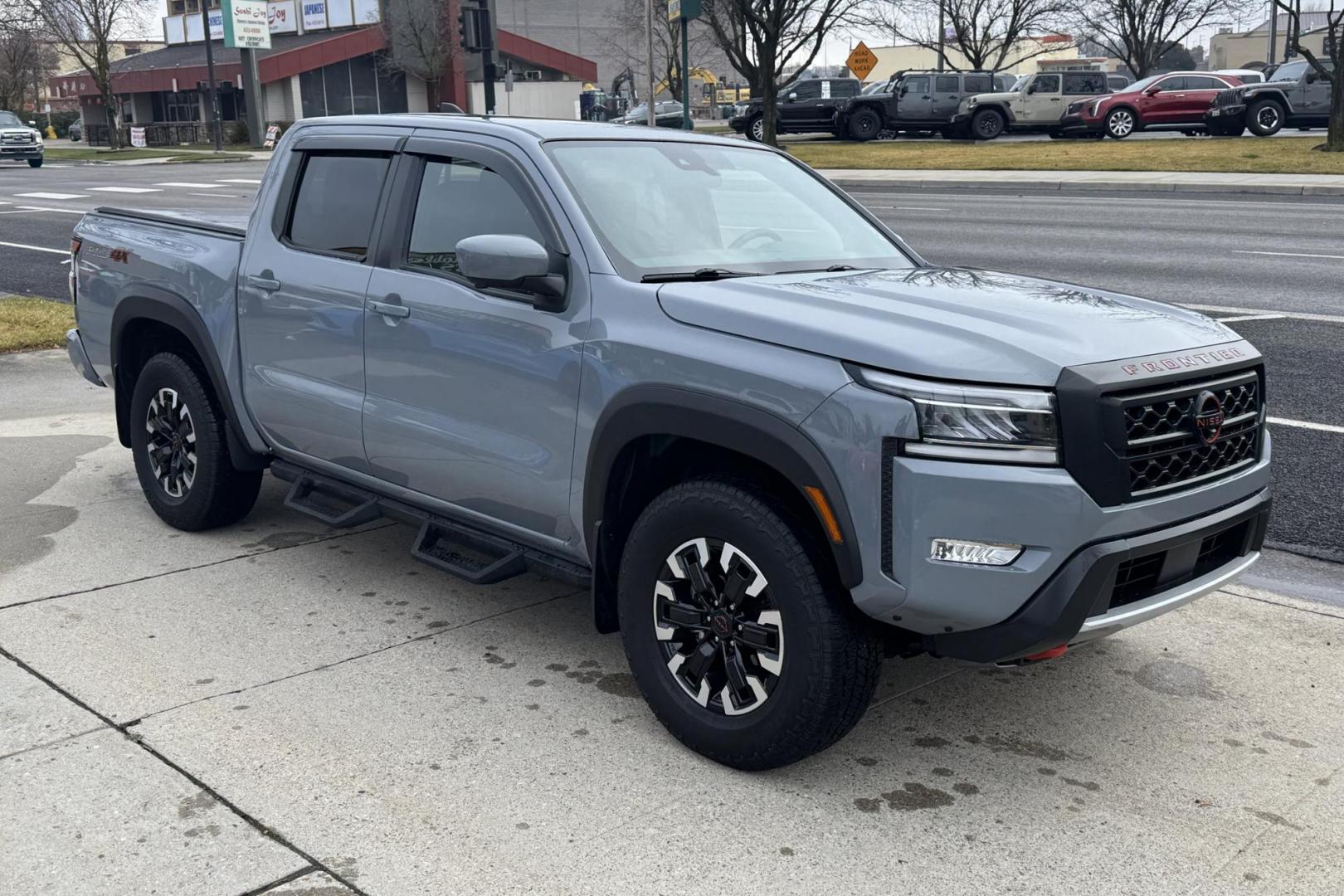 2022 Boulder Gray Pearl /Black Nissan Frontier PRO-4X (1N6ED1EK7NN) with an V6 3.8 Liter engine, Automatic 9 Speed transmission, located at 2304 W. Main St., Boise, ID, 83702, (208) 342-7777, 43.622105, -116.218658 - Remaining Factory Warranty! Huge Value For The Money! - Photo#2