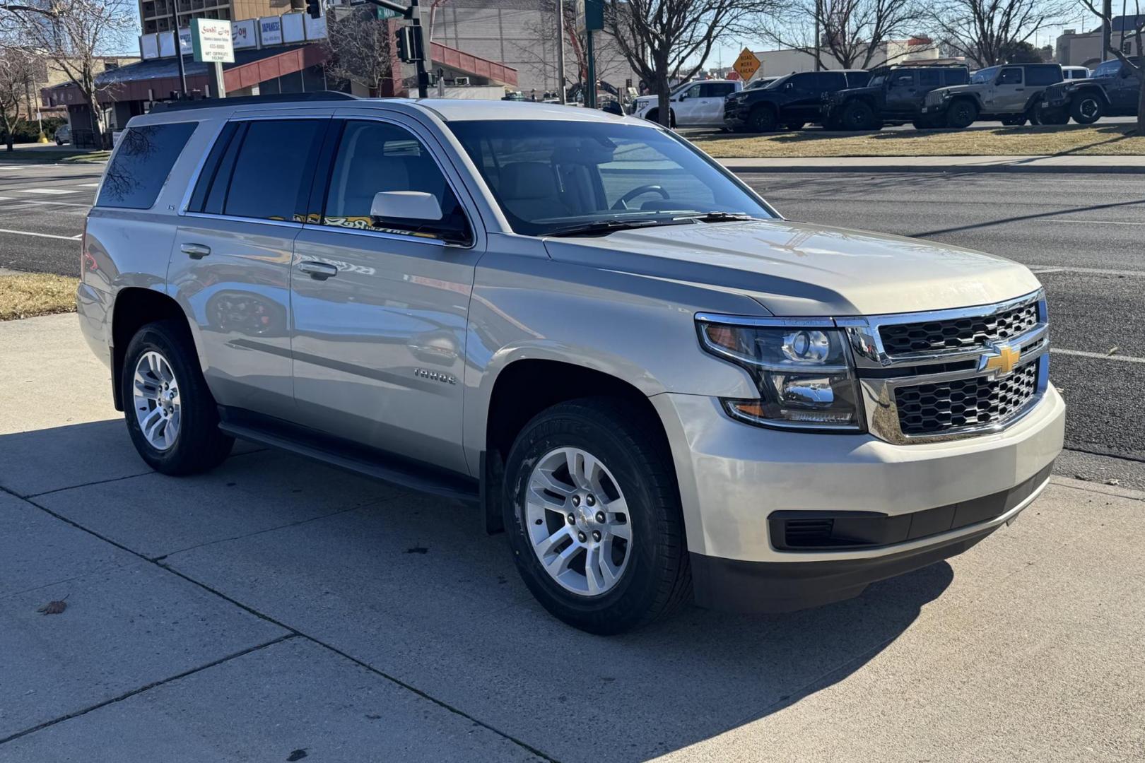 2015 Champagne Silver Metallic /Cocoa/Dune Chevrolet Tahoe LS (1GNSKAKC6FR) with an V8 5.3 Liter engine, Automatic 6 Speed transmission, located at 2304 W. Main St., Boise, ID, 83702, (208) 342-7777, 43.622105, -116.218658 - Low Mileage And Seats 8! - Photo#2