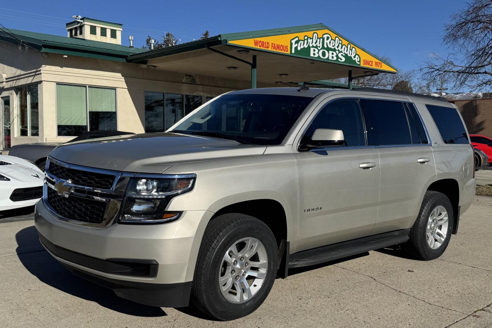 2015 Champagne Silver Metallic /Cocoa/Dune Chevrolet Tahoe LS (1GNSKAKC6FR) with an V8 5.3 Liter engine, Automatic 6 Speed transmission, located at 2304 W. Main St., Boise, ID, 83702, (208) 342-7777, 43.622105, -116.218658 - Low Mileage And Seats 8! - Photo#0